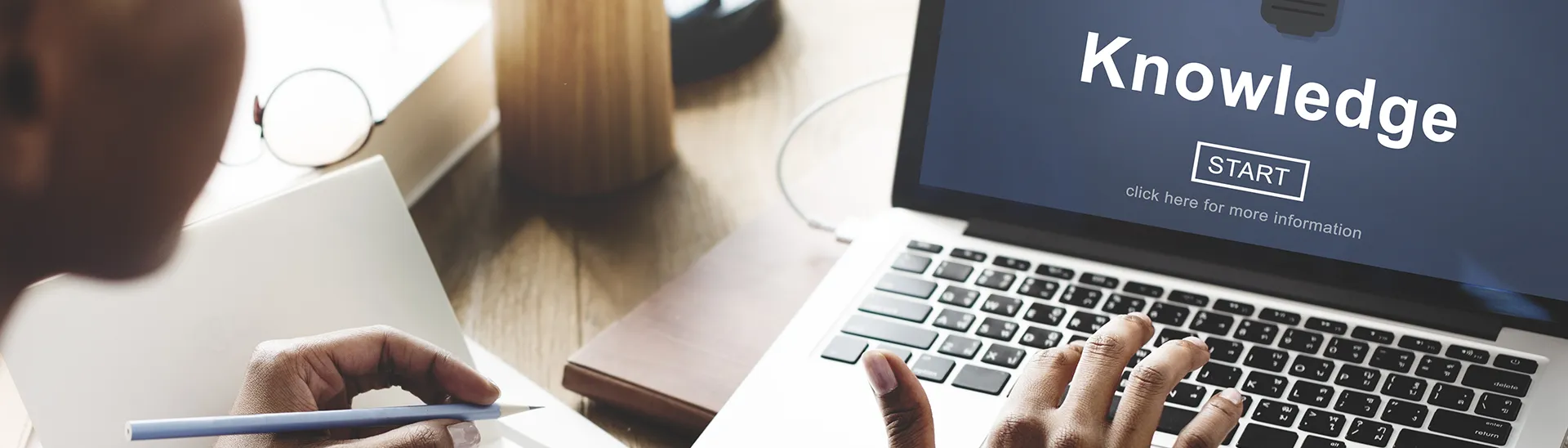 Black man looking at a computer screen about to start a new online course.