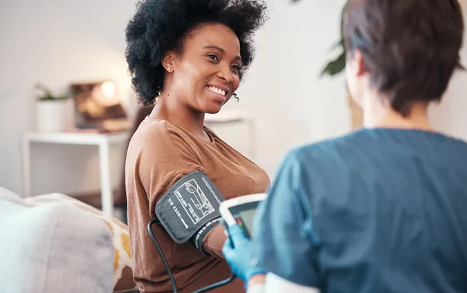 Woman taking blood pressure.