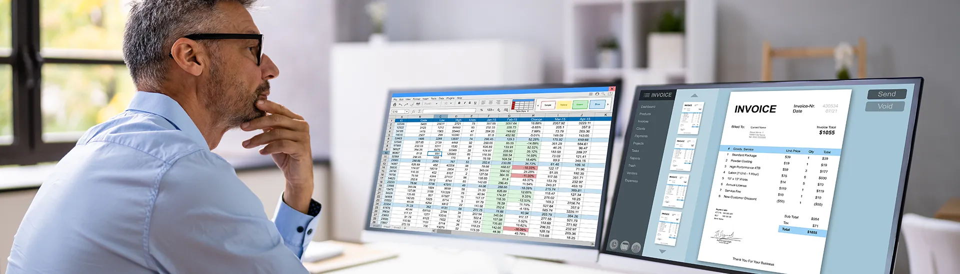 Man with black glasses sitting in front of two monitors reviewing invoice payments.